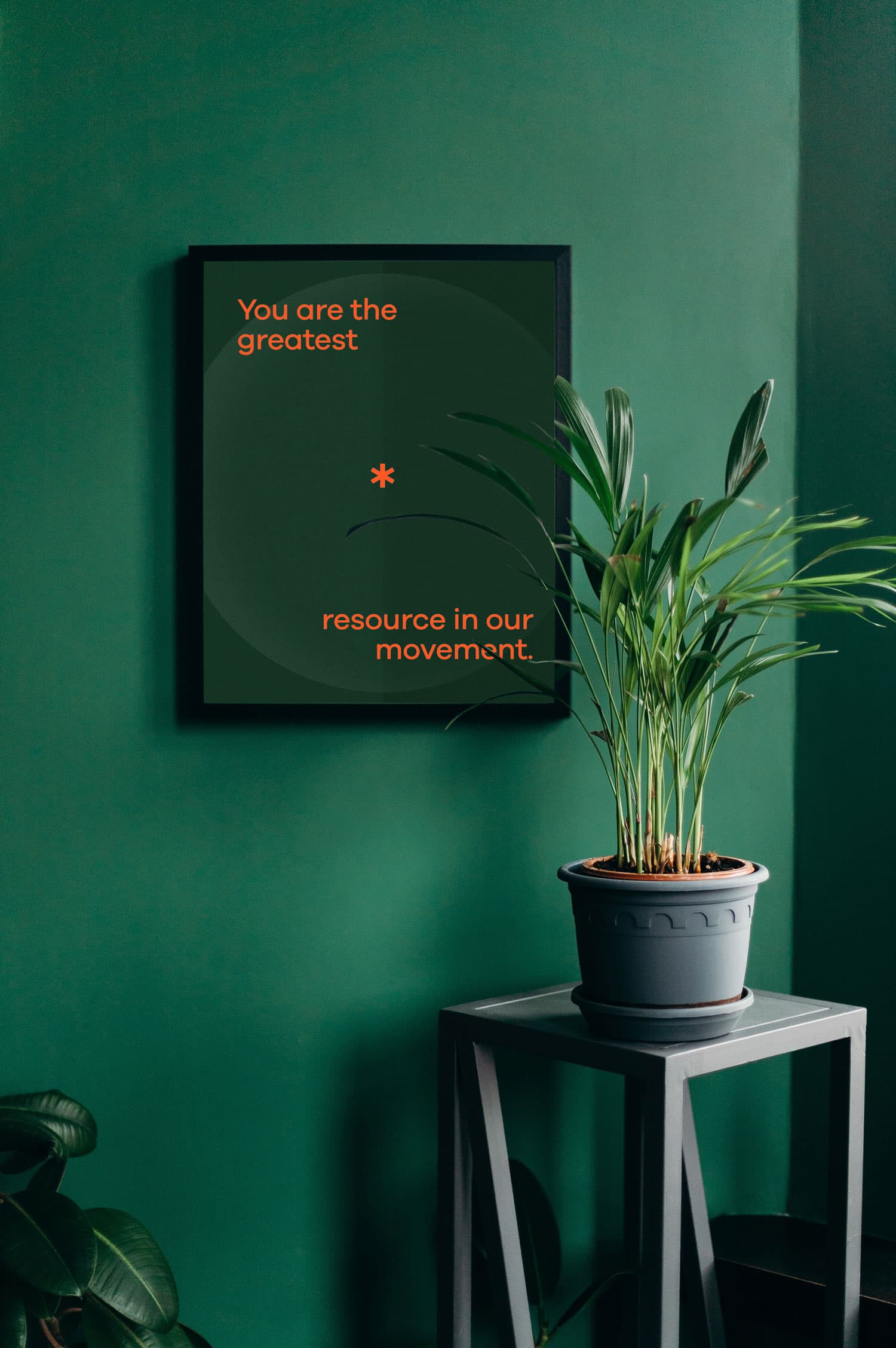 Framed poster design hanging on a green wall